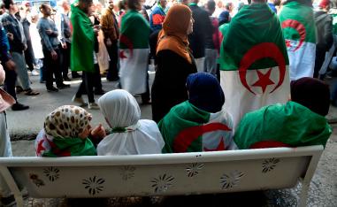 Algerians, clad in national flags, march in an anti-government demonstration in the capital Algiers
