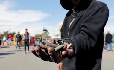 An Iraqi demonstrator shows the casings from bullets which were allegedly used by the Iraqi security forces