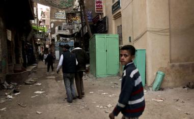 2012 photo shows a kiosk, center, used as a clinic where girls are circumcised by a barber in Giza, Egypt