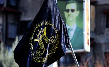 Mourners carry the flag of Islamic Jihad during the funeral of two members at Yarmuk, a Palestinian refugee camp south of Damascus