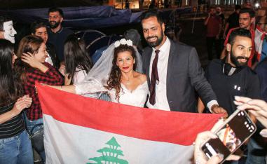 Malak Alaywe Herz poses for a picture alongside her newly-wed husband Mohammad at Riad al-Solh square in Beirut