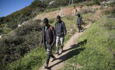 Guinean migrants walk near their hideout in the Belyounech forest, a few kilometres from Ceuta 
