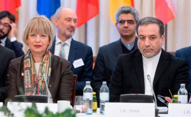 Abbas Araghchi (R), political deputy at the Ministry of Foreign Affairs of Iran, and the Secretary General of the European Union External Action Service (EEAS) Helga Schmid attend a meeting in Vienna