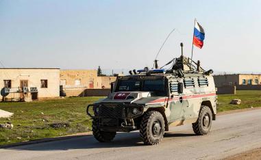 A Russian military police vehicle drives through the town of Darbasiyah in Syria's northeastern Hasakeh province