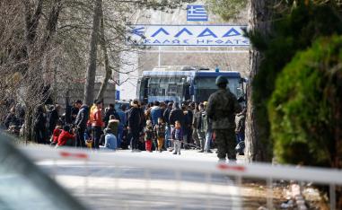 A group of asylum seekers wait in the no man's land between Turkey and Greece