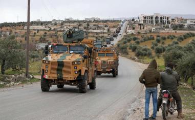 A Turkish military convoy of tanks and armoured vehicles passes near the city of Idlib