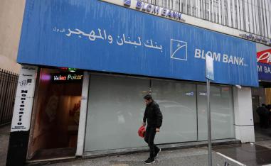 لبناني يمر بالقرب من بنك مغلق في بيروت