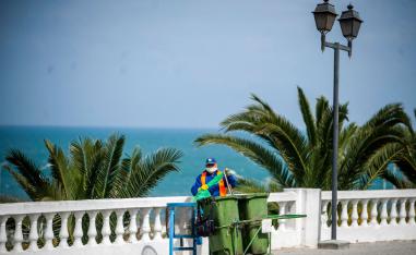 A garbage collector pictured wearing a mask in Tunis