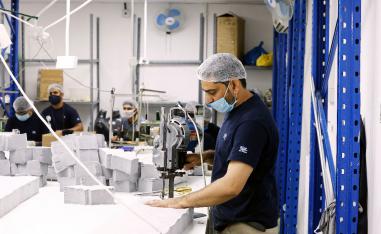 A worker sews pieces of cloth to make face masks at a factory, following the outbreak of coronavirus disease (COVID-19), in Ajman, United Arab Emirates