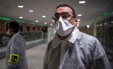 Moroccan health workers scan passengers arriving from Italy for coronavirus COVID-19 at Casablanca Mohammed V International Airport 