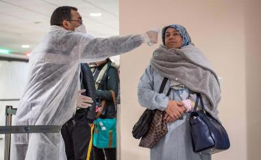 Moroccan health workers scan passengers arriving from Italy for coronavirus COVID-19 at Casablanca Mohammed V International Airport on March 3