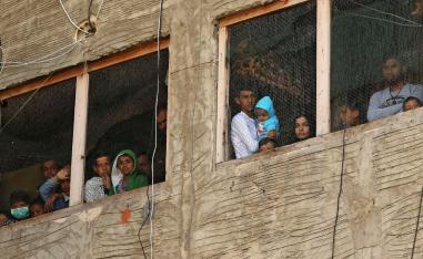 Syrian refugees pictured in a building under construction they have been using as a shelter in Sidon, Lebanon