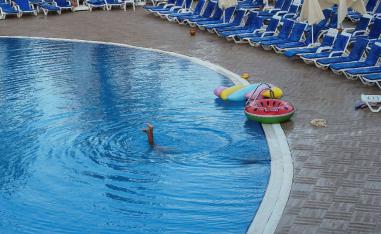 A tourist relaxes at a pool in the Mediterranean Sea resort near Bodrum, Turkey
