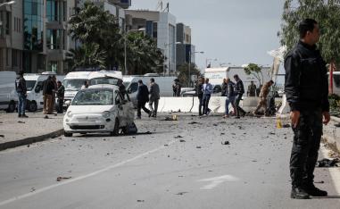 An armed Tunisian police officer at the site of an explosion near the US embassy
