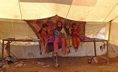 Yemeni children gather inside a tent at a camp for displaced people in the Khokha district of the western province of Hodeidah 