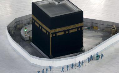Workers disinfect the ground around the Kaaba in Mecca