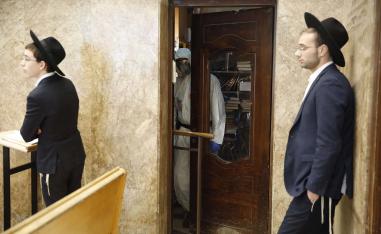 Ultra-Orthodox men pray in a synagogue 