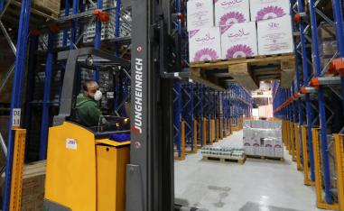 A worker wears a protective face mask as he works at Bohsali food warehouse