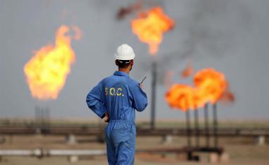 Iraqi oil worker speaks on a radio transciever at an oil refinery in the southern town Nasiriyah