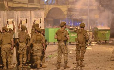 Lebanese soldiers with riot gear deploy during clashes with anti-government protesters in the northern port city of Tripoli