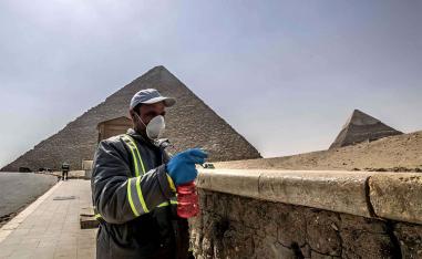 Egyptian municipality workers disinfect the Giza pyramids necropolis on the southwestern outskirts of Cairo