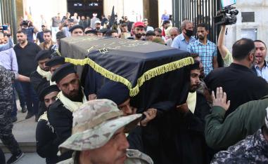 Mourners carry the coffin of Ramadan Shalah, former leader of the Islamic Jihad Movement in Palestine, during his funeral in the Syrian capital Damascus 