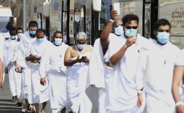 Muslim pilgrims enter Namira Mosque in Arafat, as they wear masks and keep social distance to protect themselves against coronavirus