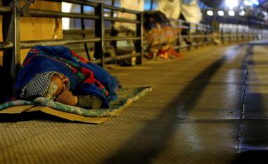 A homeless man sleeps on a pedestrian bridge in Cairo