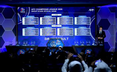 أشخاص يلتقطون صورًا لشاشة تعرض القرعة الرسمية لكأس الاتحاد الآسيوي لكرة القدم 2020