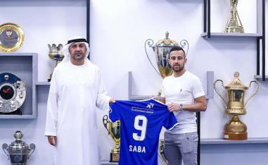 Dia Saba (R) posing with a club official during his official presentation at the club
