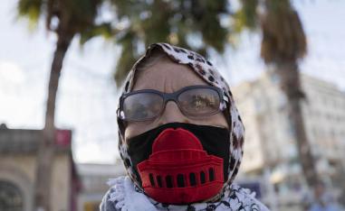 فلسطينية ترتدي كمامة عليها صورة القدس في مساندة للأسرى الفلسطينيين