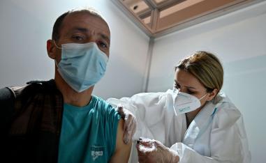رجل صربي يتلقى جرعة من لقاح كورونا