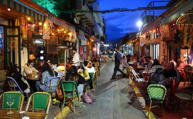 People eat at a restaurant in the Israeli coastal city of Tel Aviv