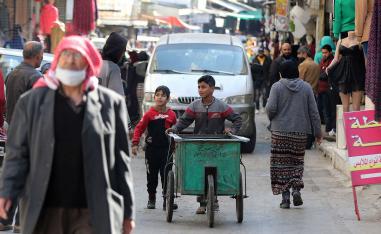 طفل أردني يستخدم عربة يدوية للعمل في منطقة الوحدات في عمان 