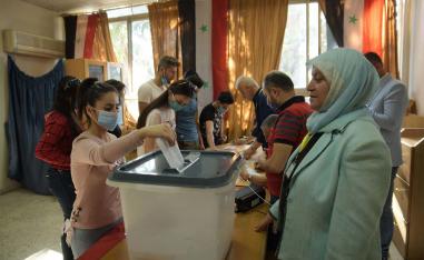 Syrians residing in Lebanon cast their vote during voting for the upcoming presidential election 