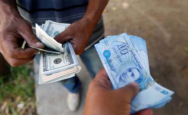 The law will reduce taxes for real estate investors and allow companies to settle foreign exchange violations by paying the fees due plus interest of 10%