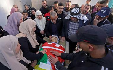 Parents of 16-year-old Palestinian Qusai Hamamrah mourn over his body during his funeral in the village of Husan, north of Bethlehem 