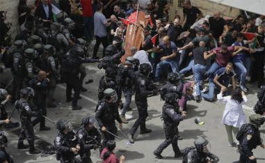Israeli police beat mourners as they carried the casket of slain Shireen Abu Akleh during her funeral in east Jerusalem