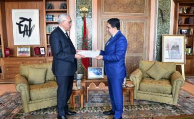 Algerian Minister of Justice Abderrachid Tabi, left, hands a letter of invitation extended to King Mohammed VI, to Morocco's Foreign Minister Nasser Bourita