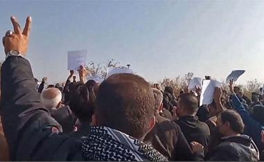 Crowds snaked through the local cemetery and thronged Amini’s grave