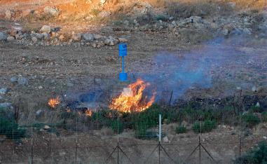 Smoke billows from a fire caused by the Lebanese in the blue line area