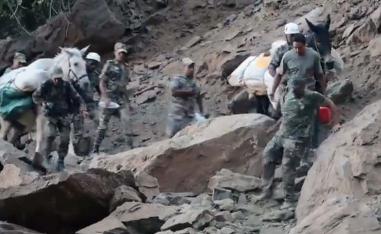 Braving the rugged terrain and aftershocks to bring relief to quake-affected villagers
