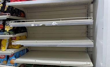 Empty shelves are seen in the rice section inside a supermarket in Tunis