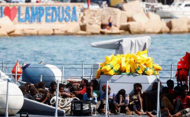 Migrants arrive on an Italian Coast Guard vessel after being rescued at sea, on the Sicilian island of Lampedusa
