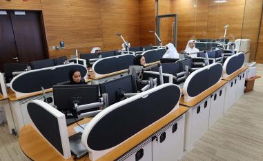 Qatari diplomats work inside an operation room set up to coordinate the truce and release of hostages between Israel and Hamas