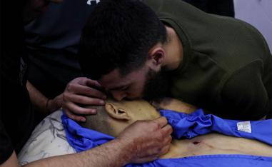 A Palestinian man bids farewell to a relative killed in an Israeli army raid on Jenin at the mortuary 