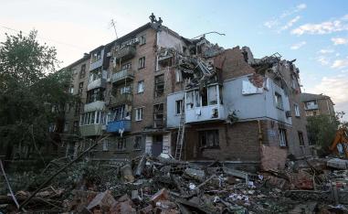 Rescuers work at a site of a residential building in kharkiv hit by a Russian missile strike