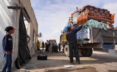 Displaced Palestinian families load their belongings on trucks to leave Rafah towards Khan Yunis