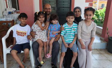 Samer Abu Della, displaced Lebanese from southern border village of Yarine, poses for a picture with his family