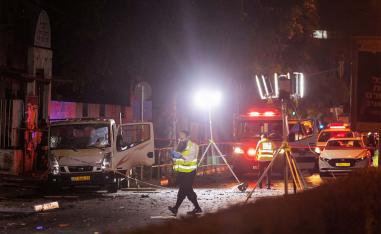Israeli security and emergency responders work at the site of a bomb blast in Tel Aviv